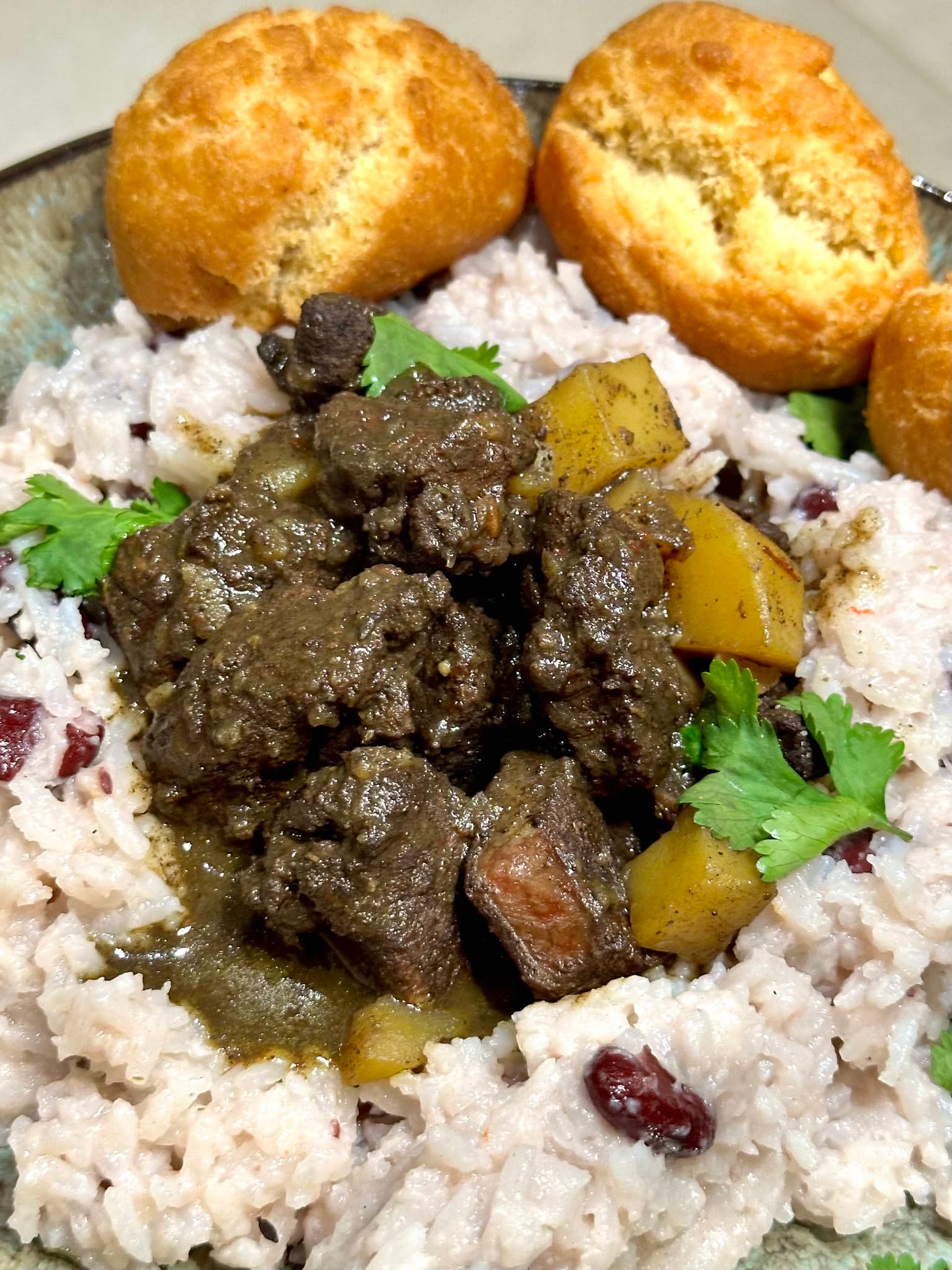 Curry Goat with Rice ‘n’ Peas & Caribbean Dumplings