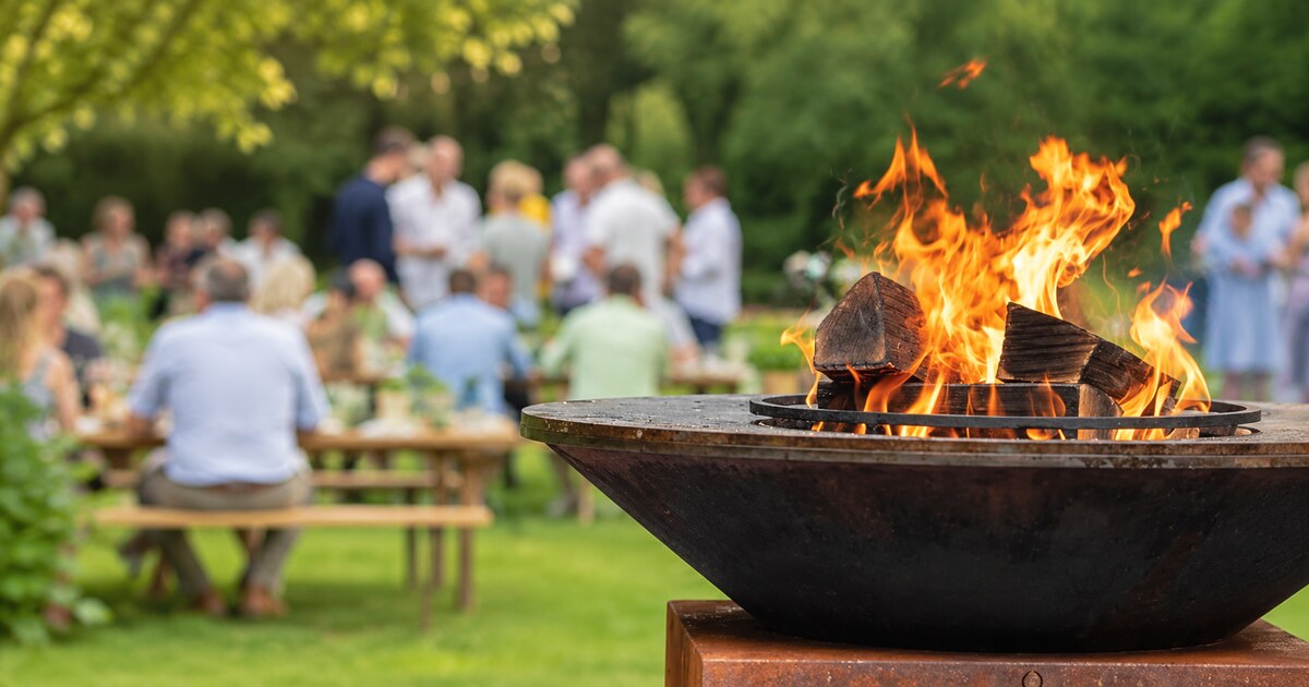 Illustrative open fire pit at a countryside food festival.